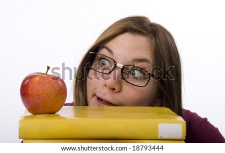 Close-up view of nerdy female student looking at apple.