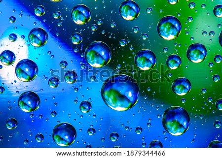 Abstract background about water or space. Multicolored stylish drops. Unusual splashes. It looks like the universe, planets and stars.