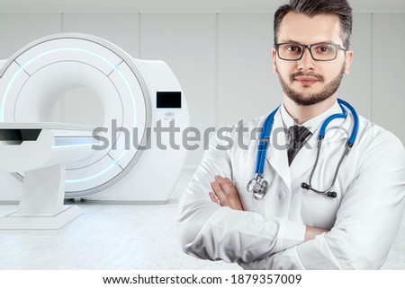 Doctor on the background of the MRI machine, medical concept. Modern technologies, the future of medicine, scientific research