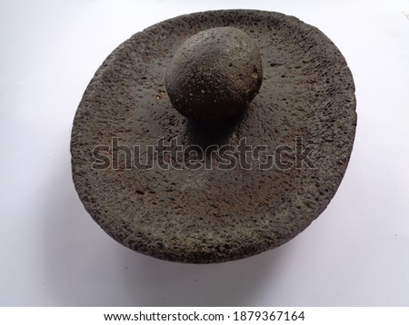 Stone Mortar and Pestle isolated on white background, Stone mortar is an important tool in making various types of chili sauce in Indonesian cuisine