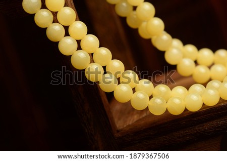 Beeswax amber bracelet necklace on a retro dark background