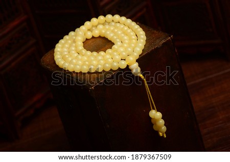 Beeswax amber bracelet necklace on a retro dark background