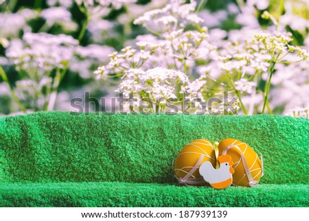 Easter decoration with flowers in the background. Eggs and Turkish towel.