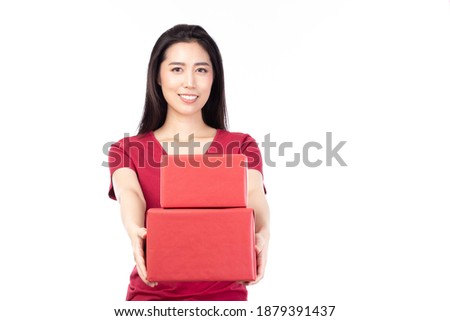 Happy pretty young woman holding gift box present in christmas or new year on white background.