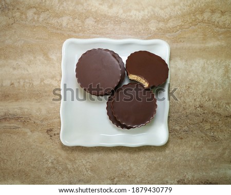 Top view of almond butter chocolate cups on a white plate.
