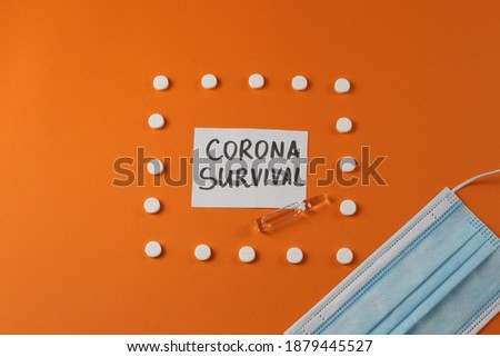 Composition: face mask, ampoule, tablets (pills). Lettering on a piece of paper: Corona Survival. Orange background