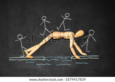 Wooden man next to the inscription Altruism on a chalk board Royalty-Free Stock Photo #1879457839
