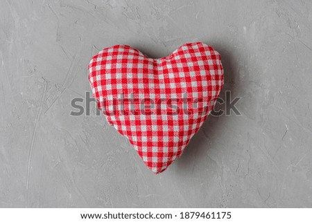 Valentines day background. Handmade textile heart on gray concrete background. minimal concept. top view
