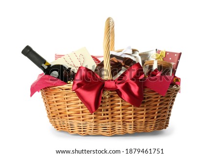 Wicker basket full of gifts isolated on white Royalty-Free Stock Photo #1879461751