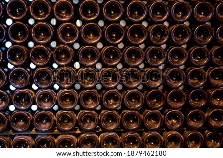 Champagne grand cru sparkling wine production in bottles in rows in dark underground cellars, Reims, Champagne, France
