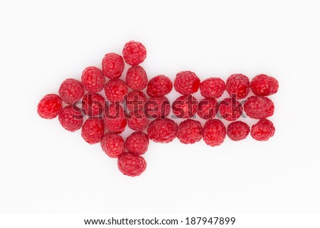 arrow of fresh red raspberries on white background
