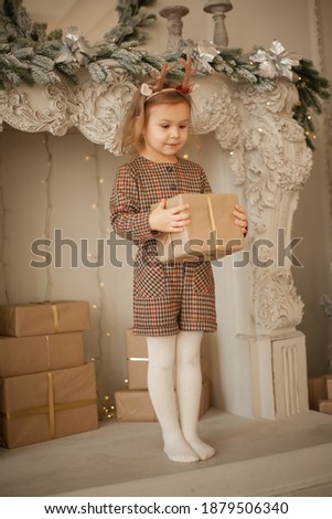 Beautiful baby girl on christmas decorated room 