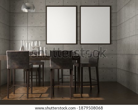 A set of tables and chairs in the room with a picture frame attached to wall.