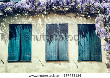 Old windows with blue shutters. Traditional French house