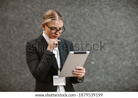 Portrait of successful businesswoman holding digital tablet



