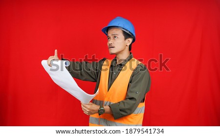 Asian worker man wearing uniform, helmet, view  paper project isolated red background