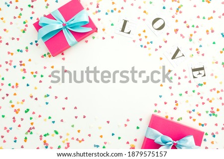 Valentines day composition with love inscription and gifts on white background. Flat lay, top view.