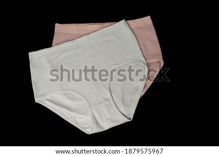 grey and pink women's high waist cotton panties on black background top view Royalty-Free Stock Photo #1879575967