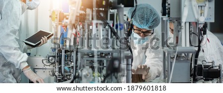 Inovation design engineer and doctor team Diverse industries Expert, Programming, and Robotic Hand Handling Bright hi-tech facility Scientists in sterile clothing working in laboratory.  Royalty-Free Stock Photo #1879601818