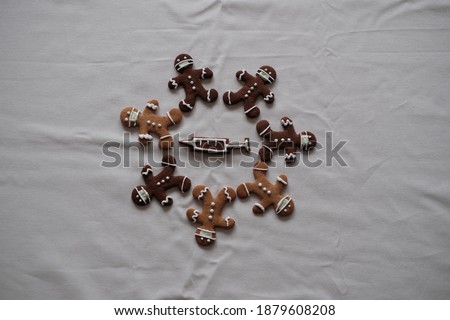 Gingerbread people wearing a mask during the 2020 coronavirus epidemic at Christmas, coperation against Covid-19, Sars-CoV-2, fight against coronavirus, waiting for vaccination against coronavirus