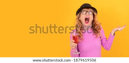 woman with glass of wine pointing isolated on background