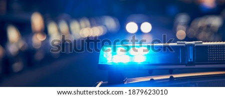 Siren light on roof of police car at street. Themes crime and emergency panoramic banner. Royalty-Free Stock Photo #1879623010