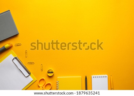 Workplace with office supplies on bright trendy yellow background. Top view, flat lay, copy space, mockup. Business and education concept, freelance, remote work