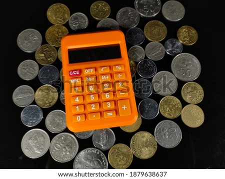Selective focus.Calculator and coins on black background.Business and money concpet idea.