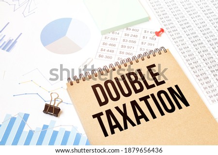 Notepad with text DOUBLE TAXATION. Diagram and white background