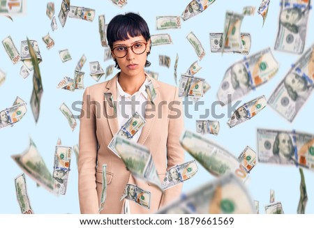 Young brunette woman with short hair wearing business jacket and glasses depressed and worry for distress, crying angry and afraid. sad expression.