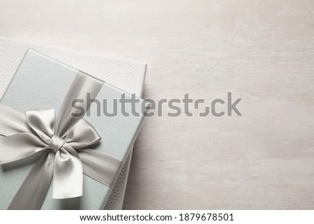 Elegant gift boxes on white table, top view. Space for text