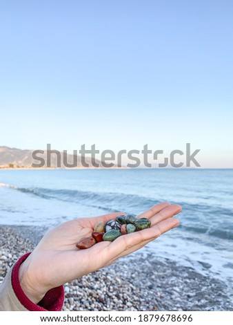 Beautiful small sea stones on the hand