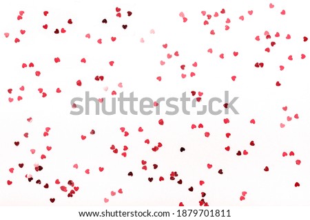 Hearts sequins on a white background, flat lay top view