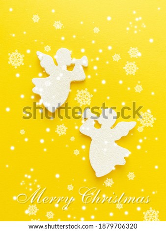 christmas card with two angels on yellow background