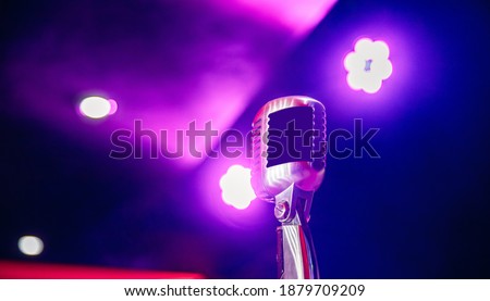 Close-up Retro vintage microphone on blurred multicolored background.