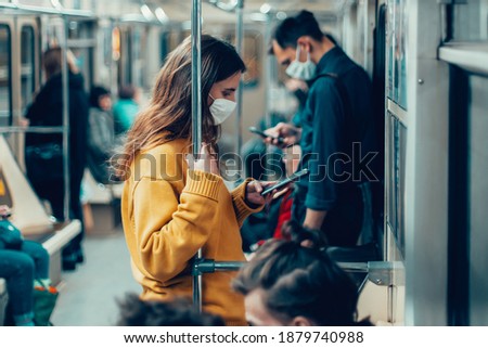 variety of passengers ride the subway car Royalty-Free Stock Photo #1879740988