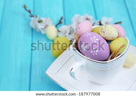 Easter composition with flowering branches on wooden table close-up