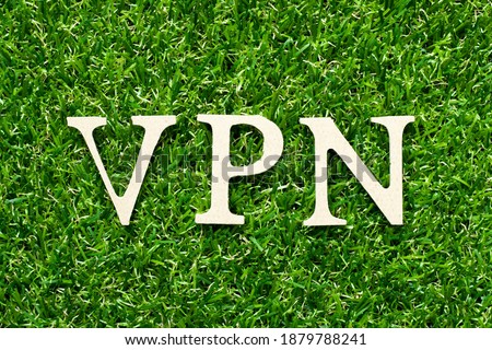 Wood alphabet letter in word VPN (abbreviation of virtual private network) on green grass background