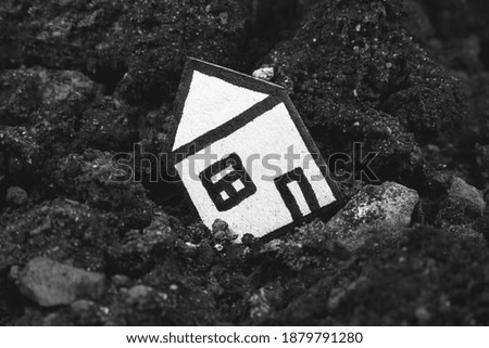 House in the soil. Сoncept of earthquake and loss of a house. Сredit debts.