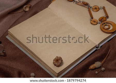 Blank notepad on brown background. Background for an inscription or logo. Antique paper. Atmospheric photography in warm colors