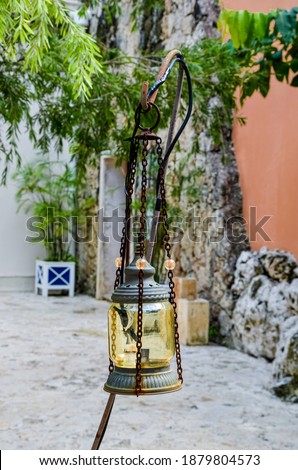Yellow Rustic Lantern hanging on a post