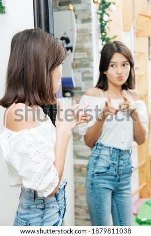 Stylish teen girl 12 year old wearing trendy clothes posing indoors
