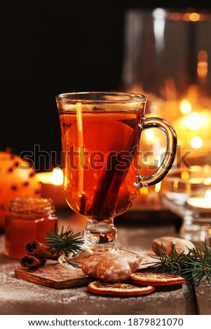 Glass of Christmas tea with cloves and cinnamon.