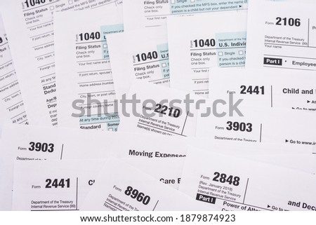 Tax concept. Many different usa tax form. 1040 form for fill in April. Tax time