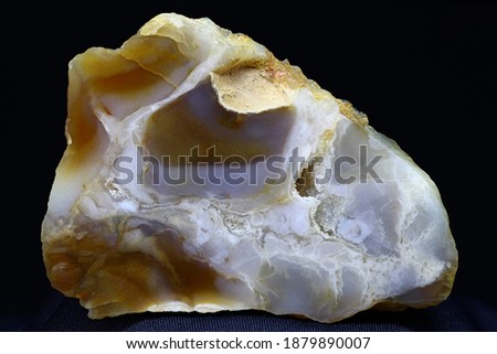 A polished plate of bluish chalcedony against a dark background. Russia
 Royalty-Free Stock Photo #1879890007