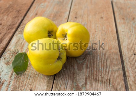 Quince, yellow ripe apple quince on wooden background