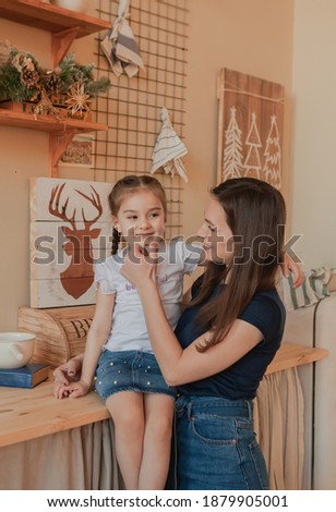 Mom and daughter loving each other, mom wipes daughter's cheek