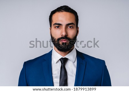 Serious successful Arabian businessman in formal attire isolated over grey background Royalty-Free Stock Photo #1879913899