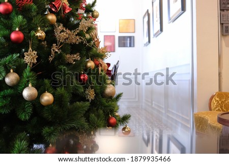 Christmas tree decoration with hanging gifts inside modern luxury house