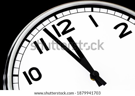 Just a few minutes to midday or midnight on a wall clock ,  close up , macro shot full frame